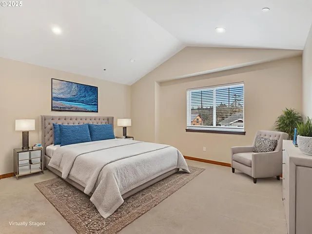 a bedroom with a large bed couch and a potted plant