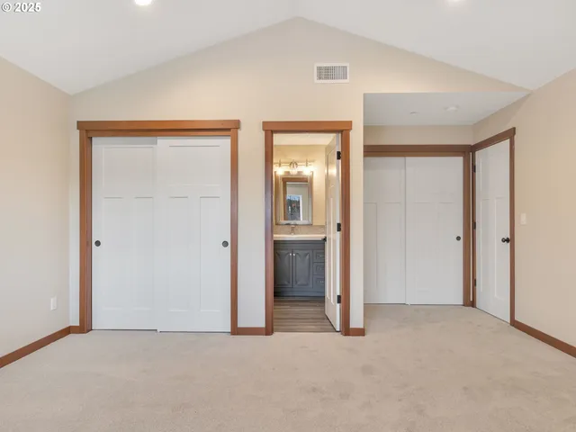 an empty room with closet and a bathroom