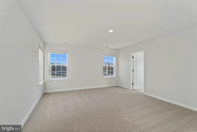 a view of an empty room and a window