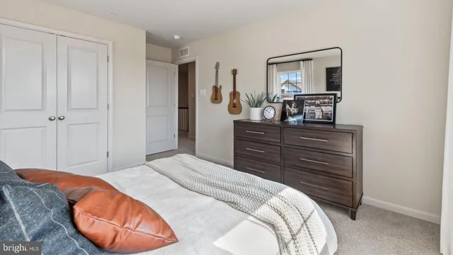 a bedroom with a bed and a mirror