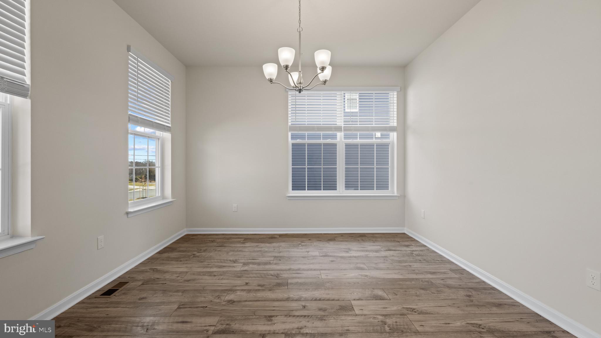 8 Comes Rdg Court Rosedale, MD 21237 - Photo 3 of 54 a view of an empty room with wooden floor and a window
