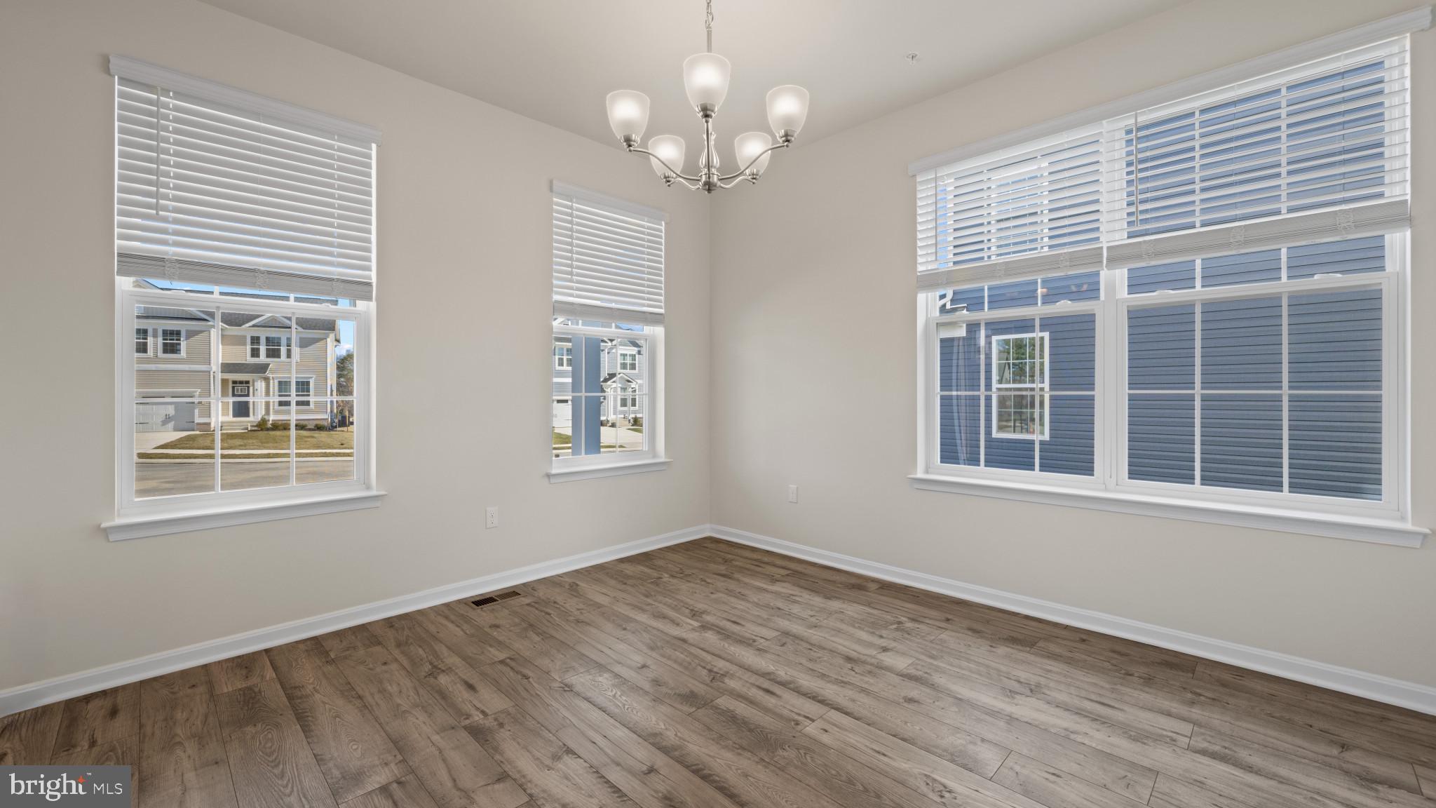8 Comes Rdg Court Rosedale, MD 21237 - Photo 4 of 54 a view of an empty room with wooden floor and a window