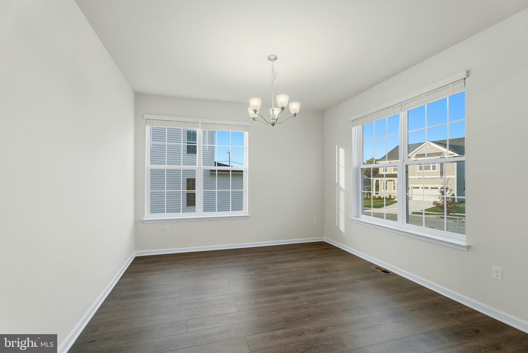 8 Comes Rdg Court Rosedale, MD 21237 - Photo 5 of 35 an empty room with wooden floor and windows