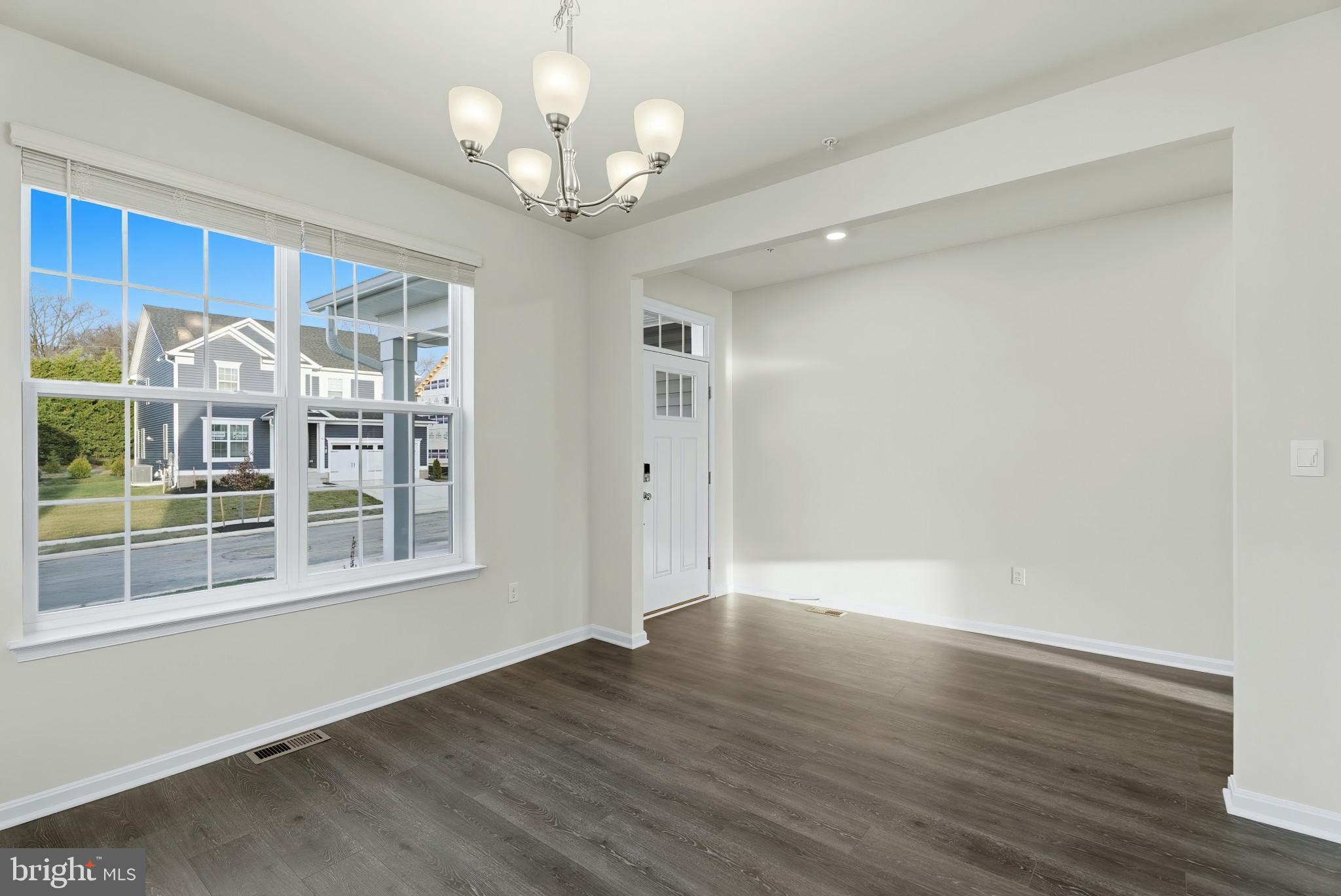 8 Comes Rdg Court Rosedale, MD 21237 - Photo 6 of 35 a view of an empty room with wooden floor and a window