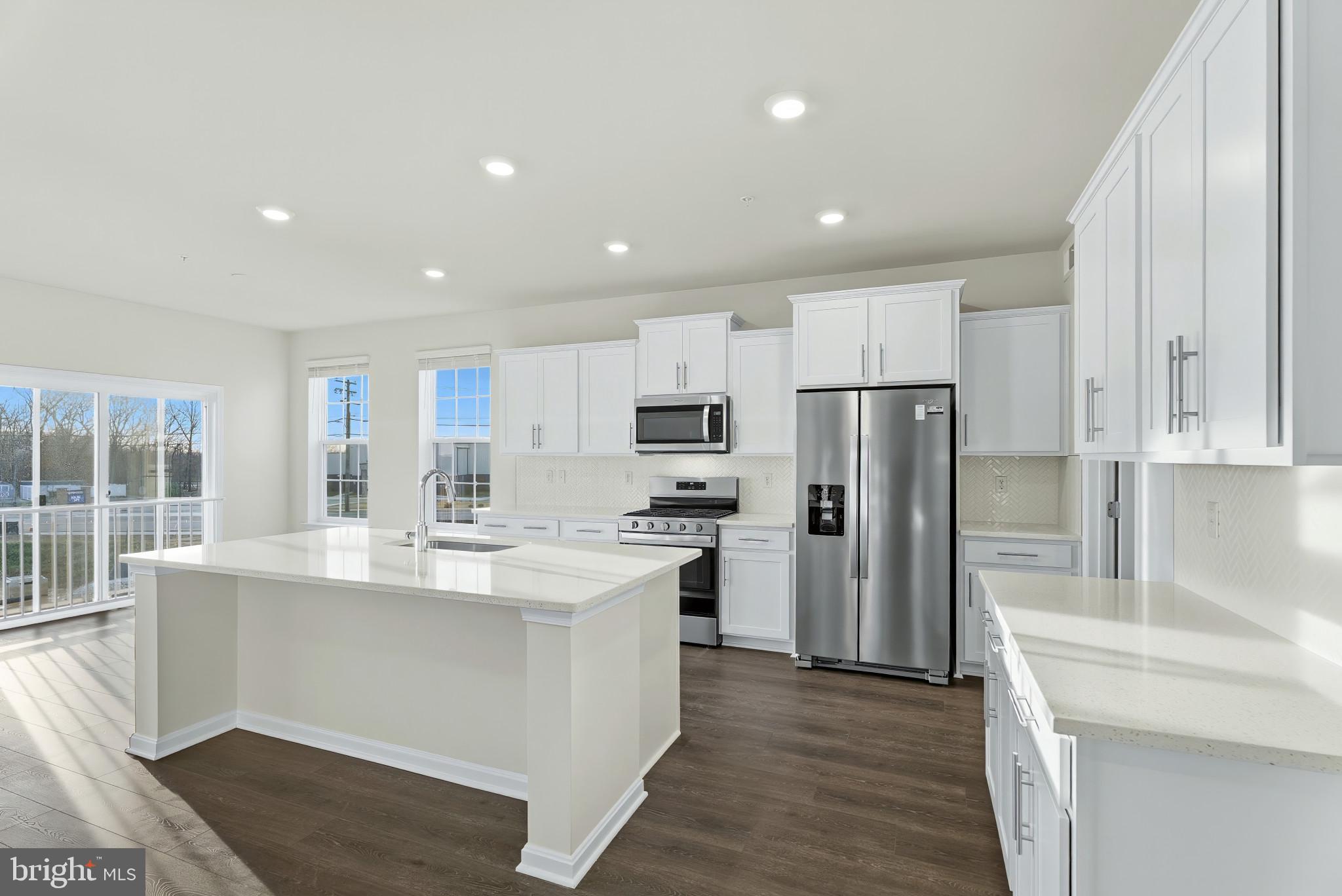 8 Comes Rdg Court Rosedale, MD 21237 - Photo 7 of 35 a kitchen with refrigerator cabinets and wooden floor