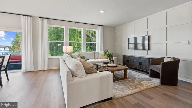 a living room with furniture and large windows