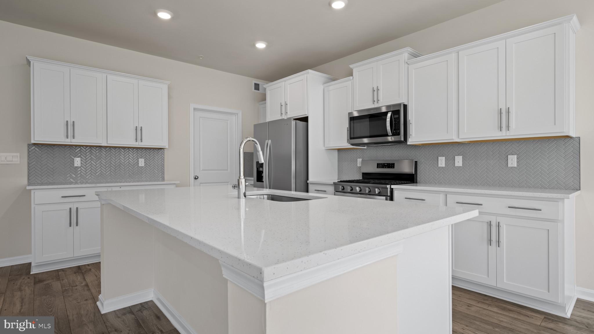 8 Comes Rdg Court Rosedale, MD 21237 - Photo 10 of 54 a kitchen with stainless steel appliances a refrigerator sink stove and white cabinets