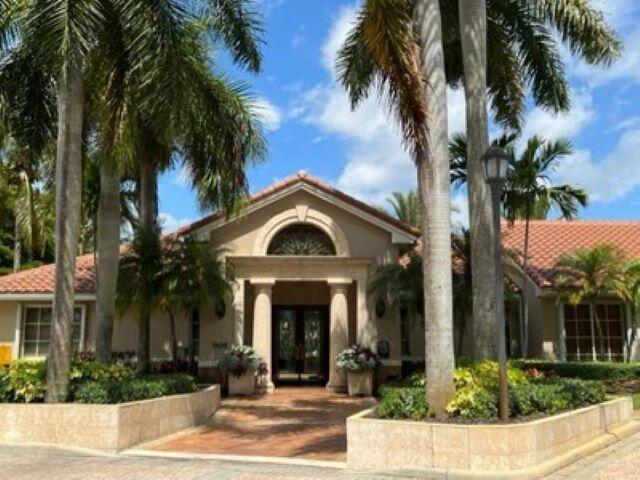 7848 Sonoma Springs Circle, Unit 202 Lake Worth, FL 33463 - Photo 13 of 16 front view of a house with a palm tree