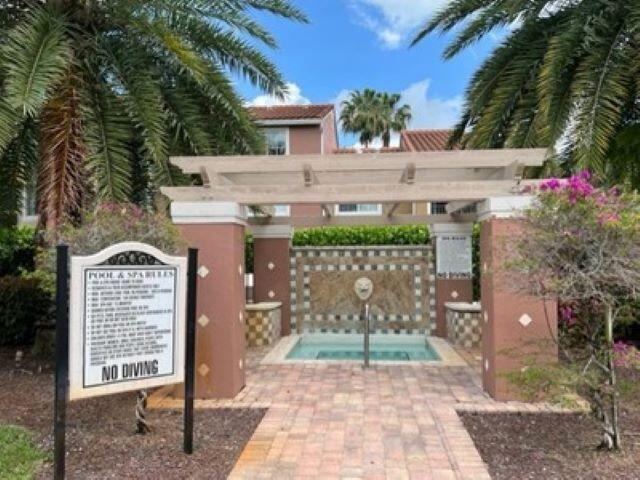 7848 Sonoma Springs Circle, Unit 202 Lake Worth, FL 33463 - Photo 16 of 16 a front view of a house with a yard