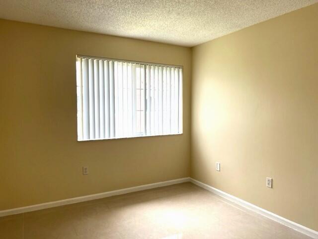 7848 Sonoma Springs Circle, Unit 202 Lake Worth, FL 33463 - Photo 9 of 16 an empty room with a window