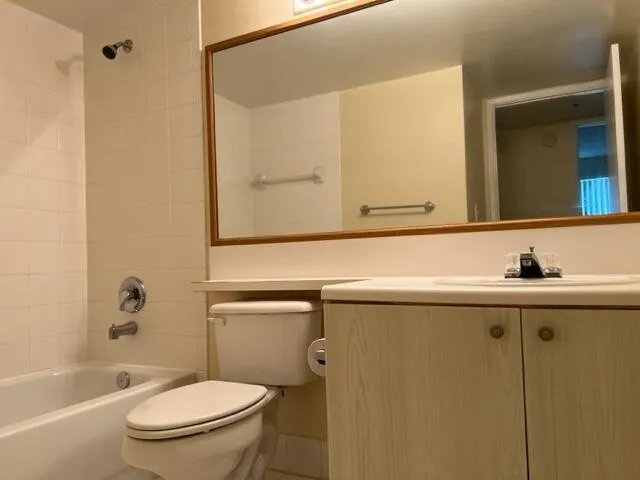 a bathroom with a sink and mirror with toilet