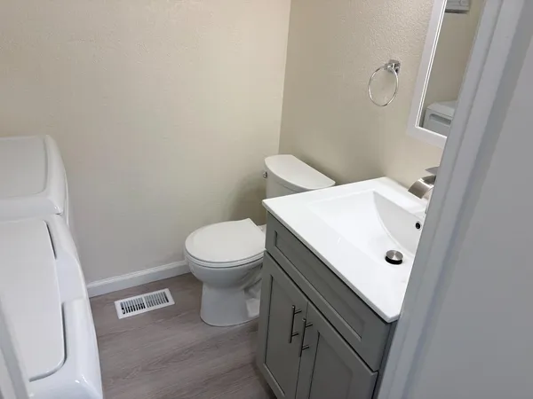 a bathroom with a toilet a sink and a mirror