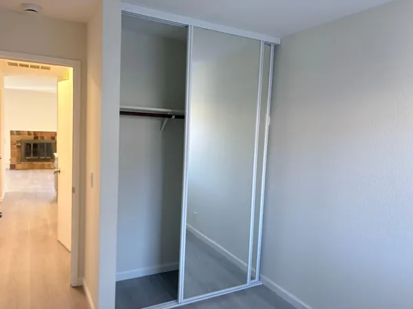 a view of closet with wooden floor
