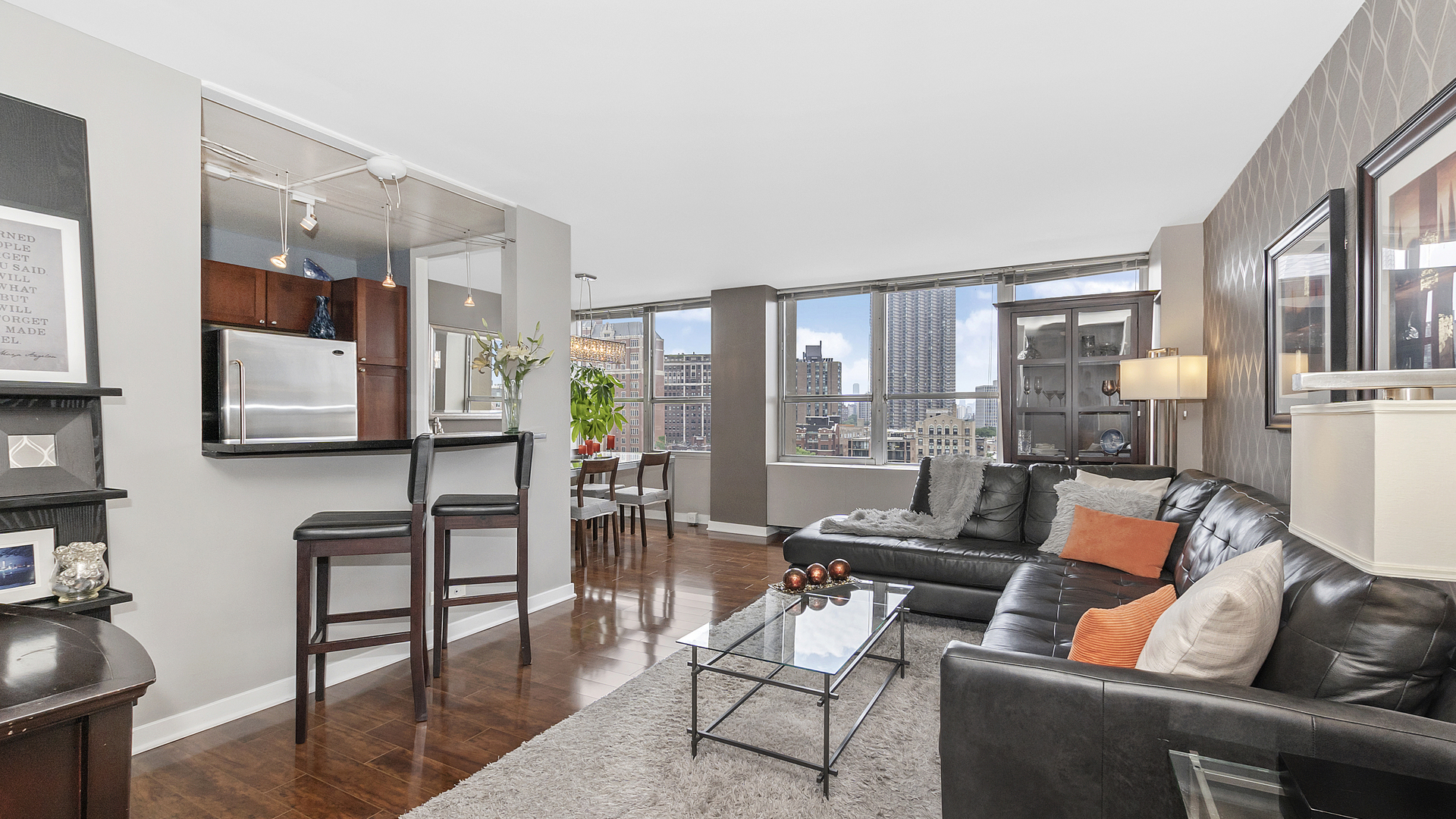 655 West Irving Park Road, Unit 915 Chicago, IL 60613 - Photo 2 of 18 a living room with furniture and floor to ceiling windows