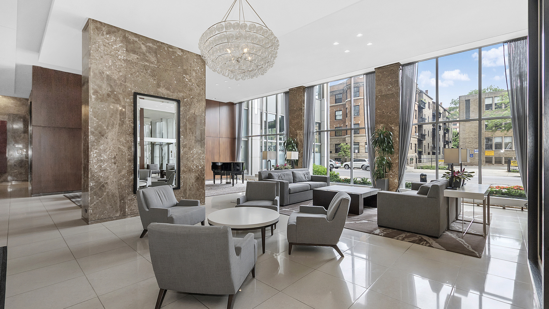 655 West Irving Park Road, Unit 915 Chicago, IL 60613 - Photo 12 of 18 a living room with furniture and a chandelier