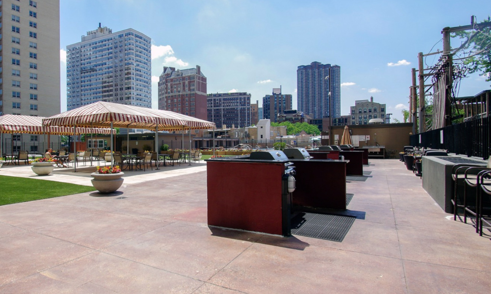 655 West Irving Park Road, Unit 915 Chicago, IL 60613 - Photo 16 of 18 a swimming pool with outdoor seating and a garden