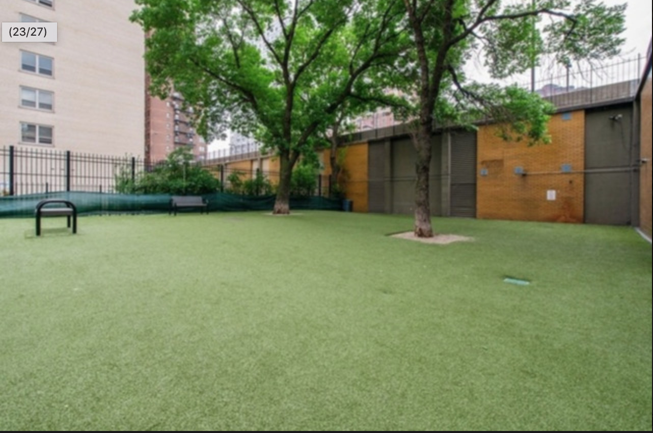 655 West Irving Park Road, Unit 915 Chicago, IL 60613 - Photo 17 of 18 a backyard of a house with table and chairs