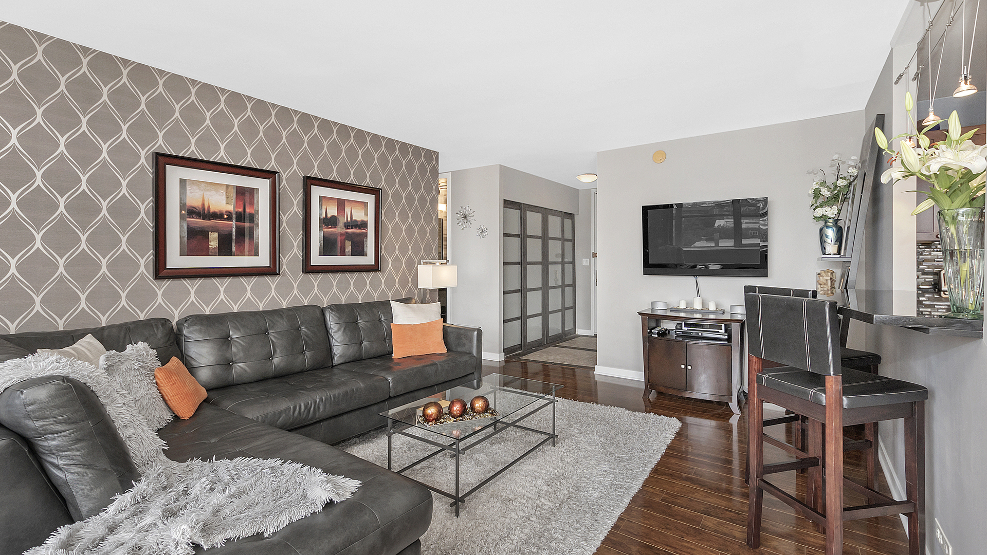 655 West Irving Park Road, Unit 915 Chicago, IL 60613 - Photo 3 of 18 a living room with furniture and a flat screen tv