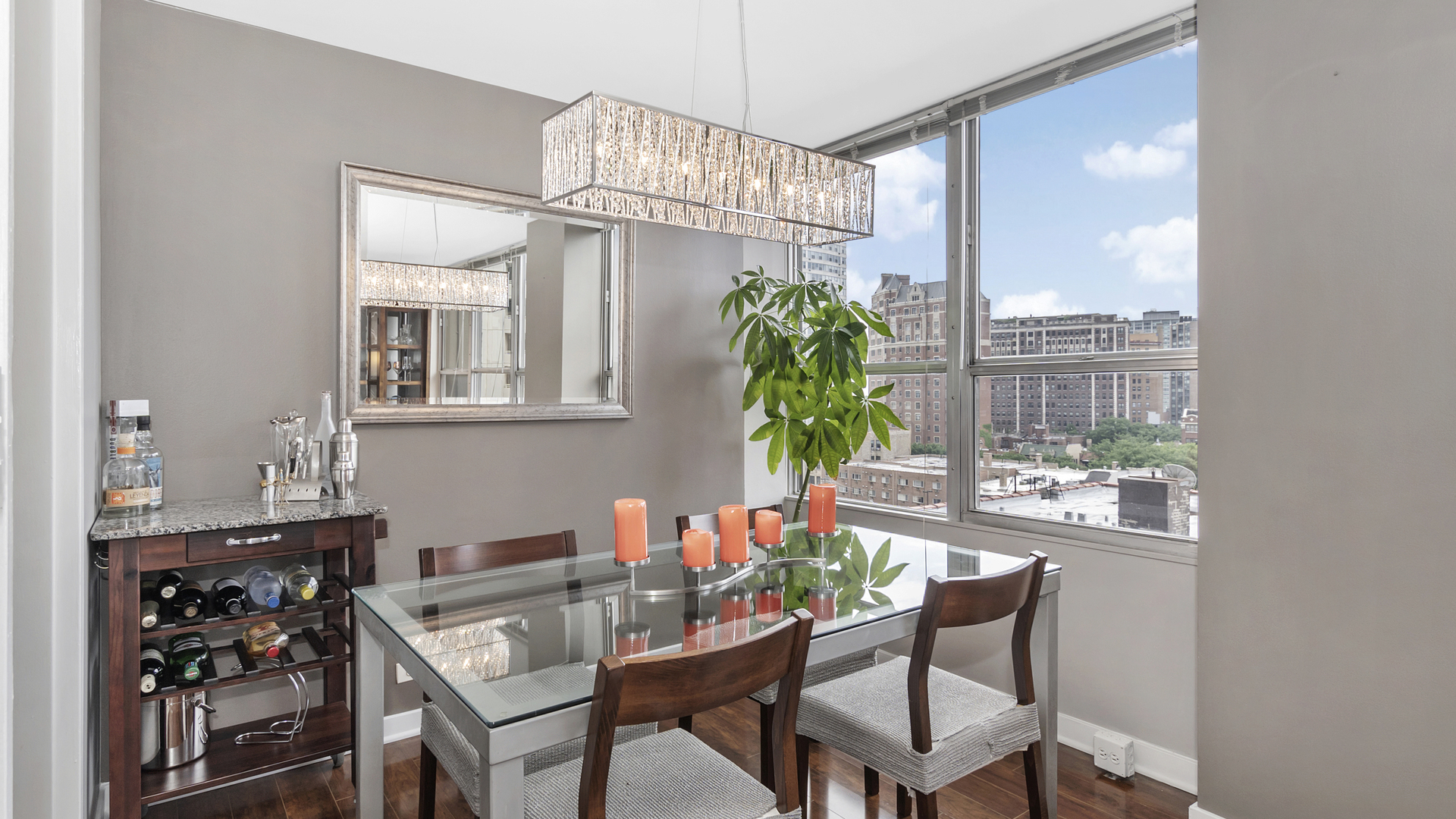 655 West Irving Park Road, Unit 915 Chicago, IL 60613 - Photo 5 of 18 a dining room with furniture and chandelier