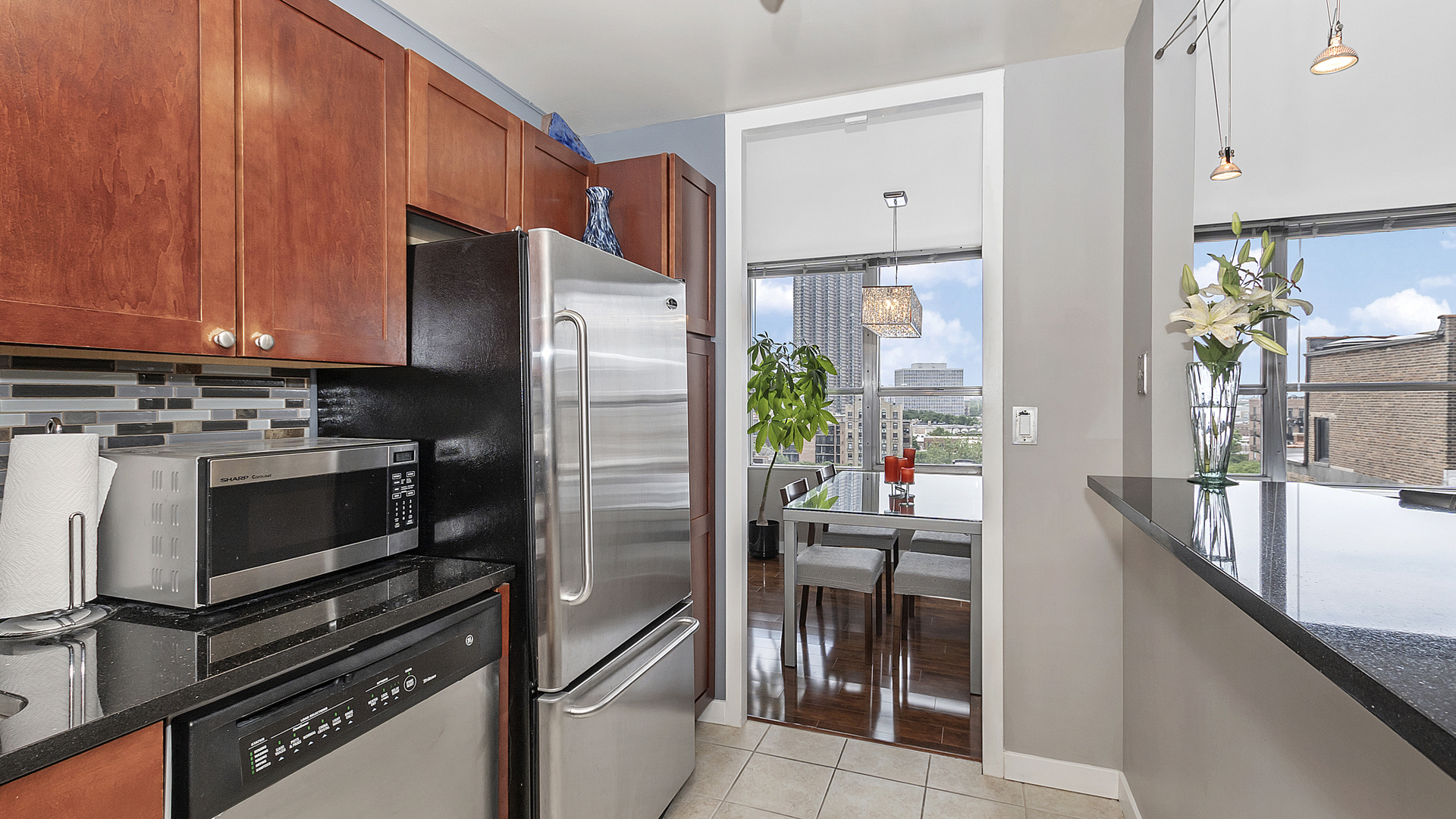 655 West Irving Park Road, Unit 915 Chicago, IL 60613 - Photo 8 of 18 a kitchen with a refrigerator stove and sink