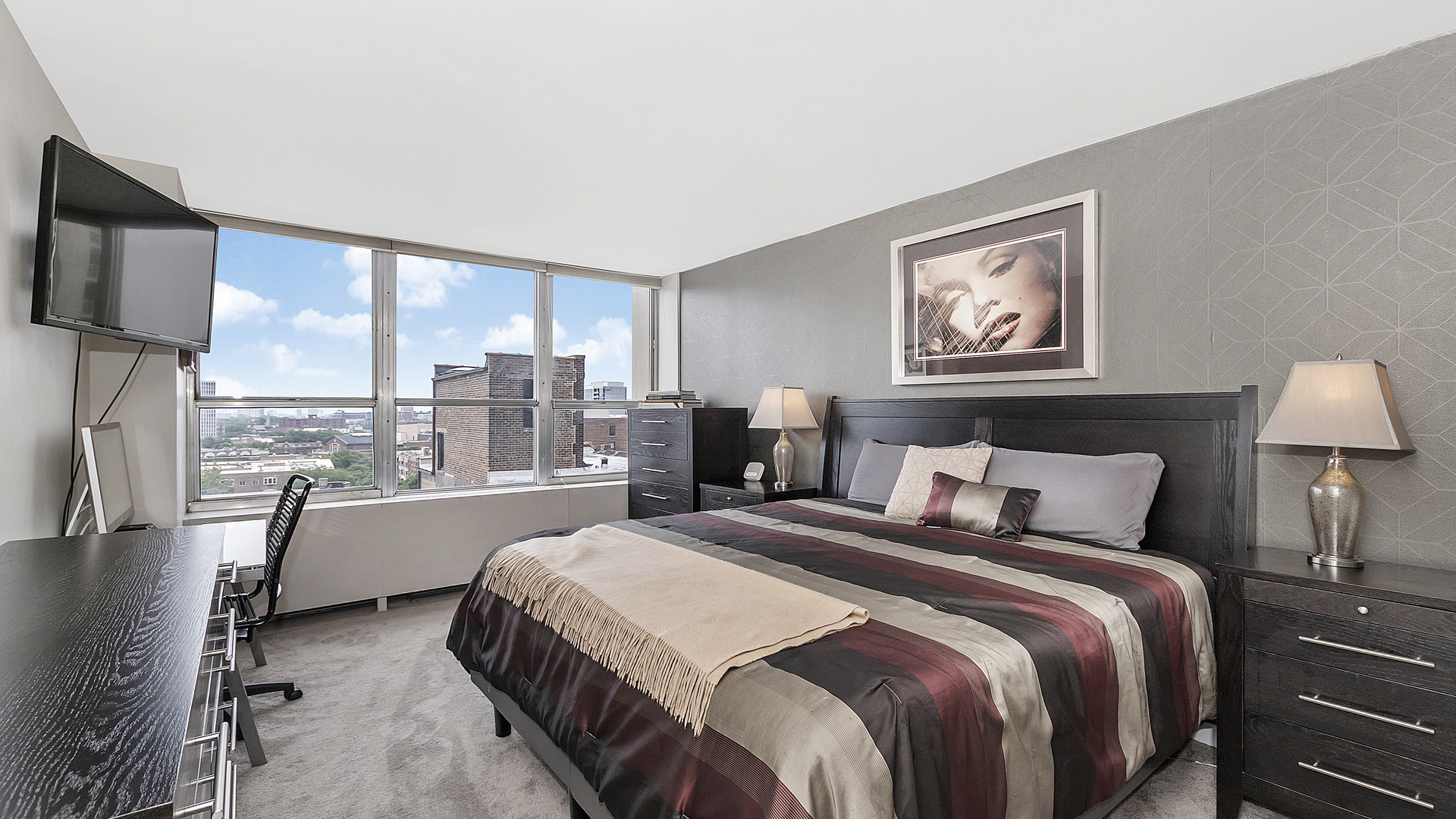 655 West Irving Park Road, Unit 915 Chicago, IL 60613 - Photo 9 of 18 a bedroom with a bed and a large window