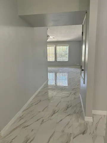 an empty room with wooden floor and a window