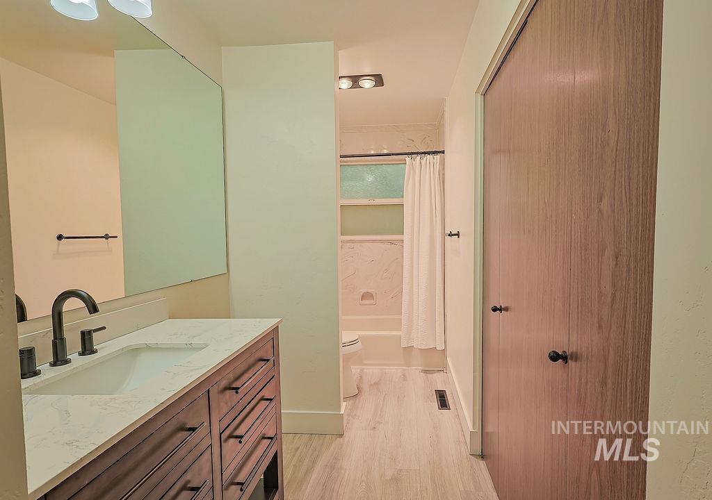 640 Morrison Street Twin Falls, ID 83301 - Photo 21 of 30 Bathroom vanity featuring a rectangular undermount sink, a dark bronze faucet, and a light-toned countertop