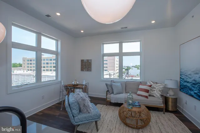a kitchen with granite countertop a sink a counter space appliances and cabinets