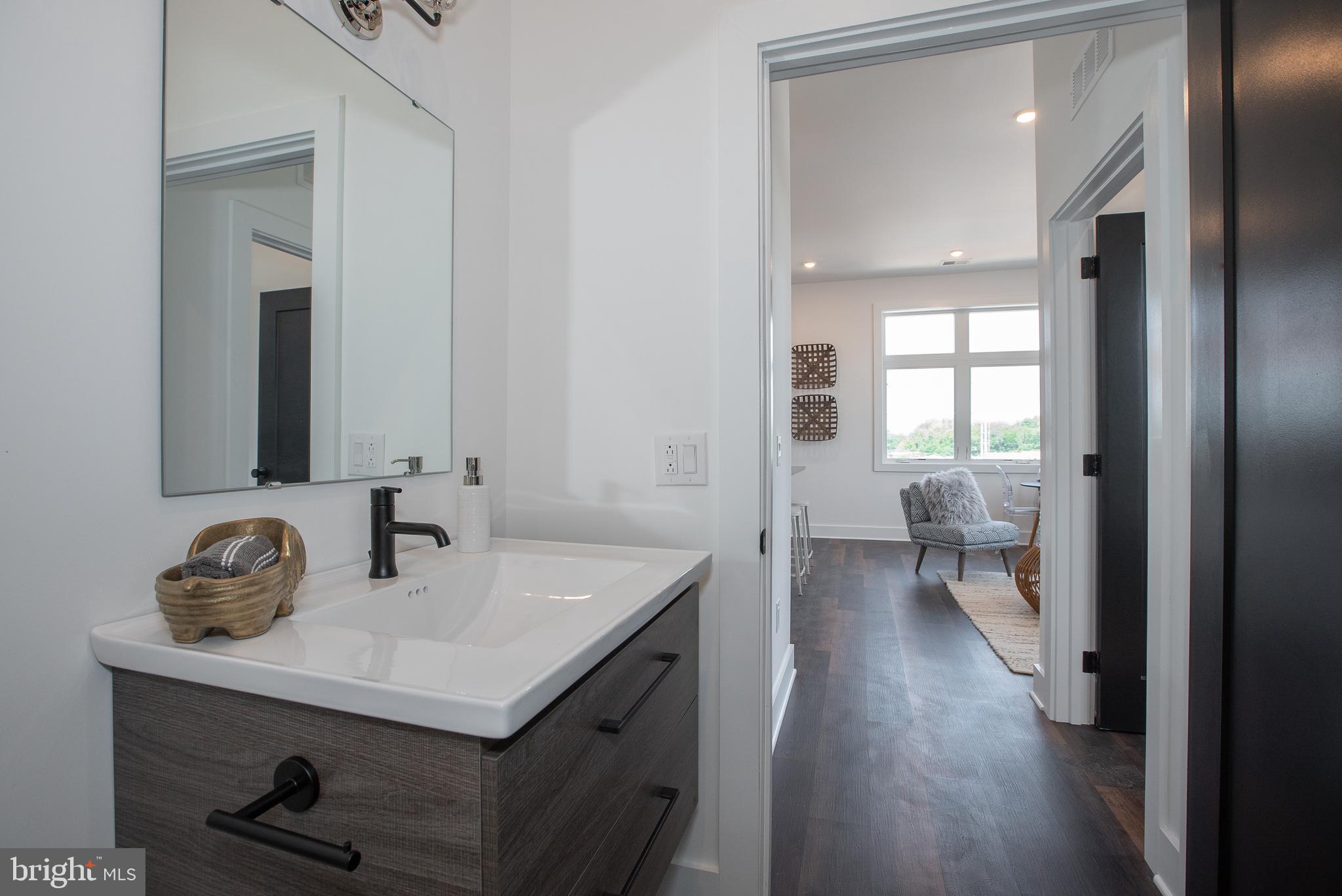 2940 West Thompson Street, Unit 302 Philadelphia, PA 19121 - Photo 28 of 43 a bathroom with a sink a toilet and a mirror