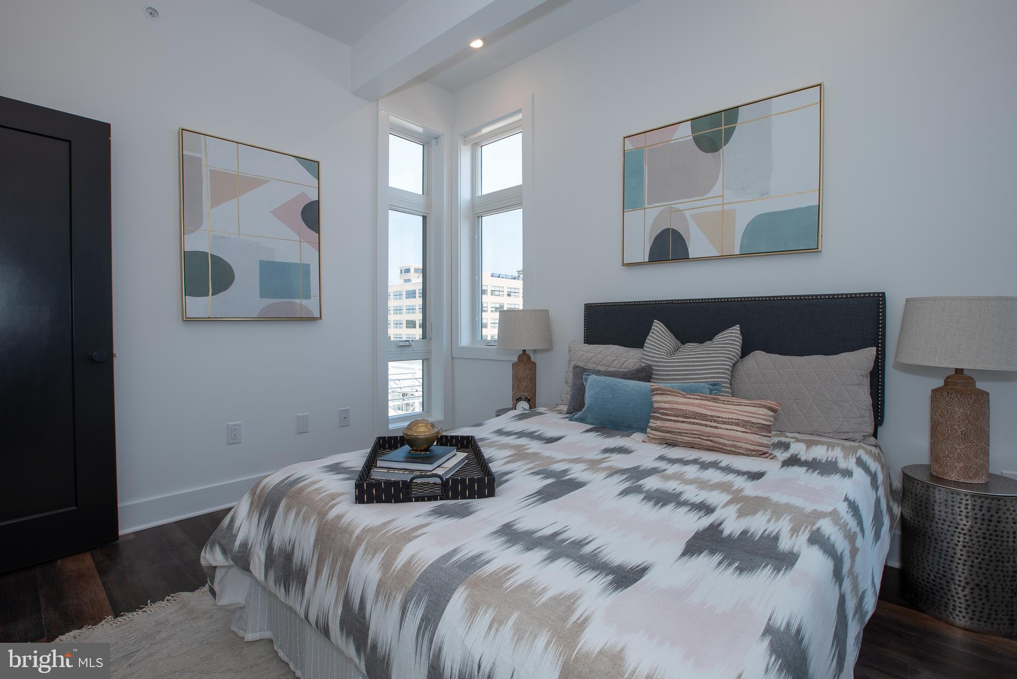 2940 West Thompson Street, Unit 302 Philadelphia, PA 19121 - Photo 31 of 43 a bedroom with a bed and painting on the wall