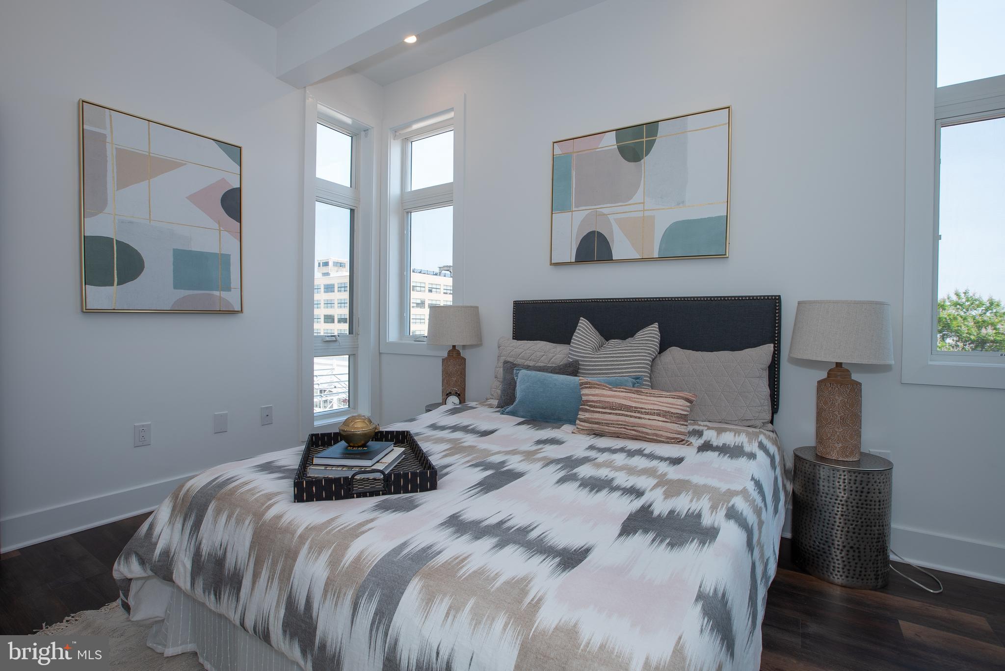 2940 West Thompson Street, Unit 302 Philadelphia, PA 19121 - Photo 32 of 43 a bedroom with a bed and wooden floor