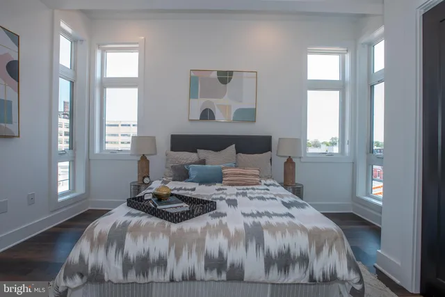 a bedroom with bed and a painting on the wall