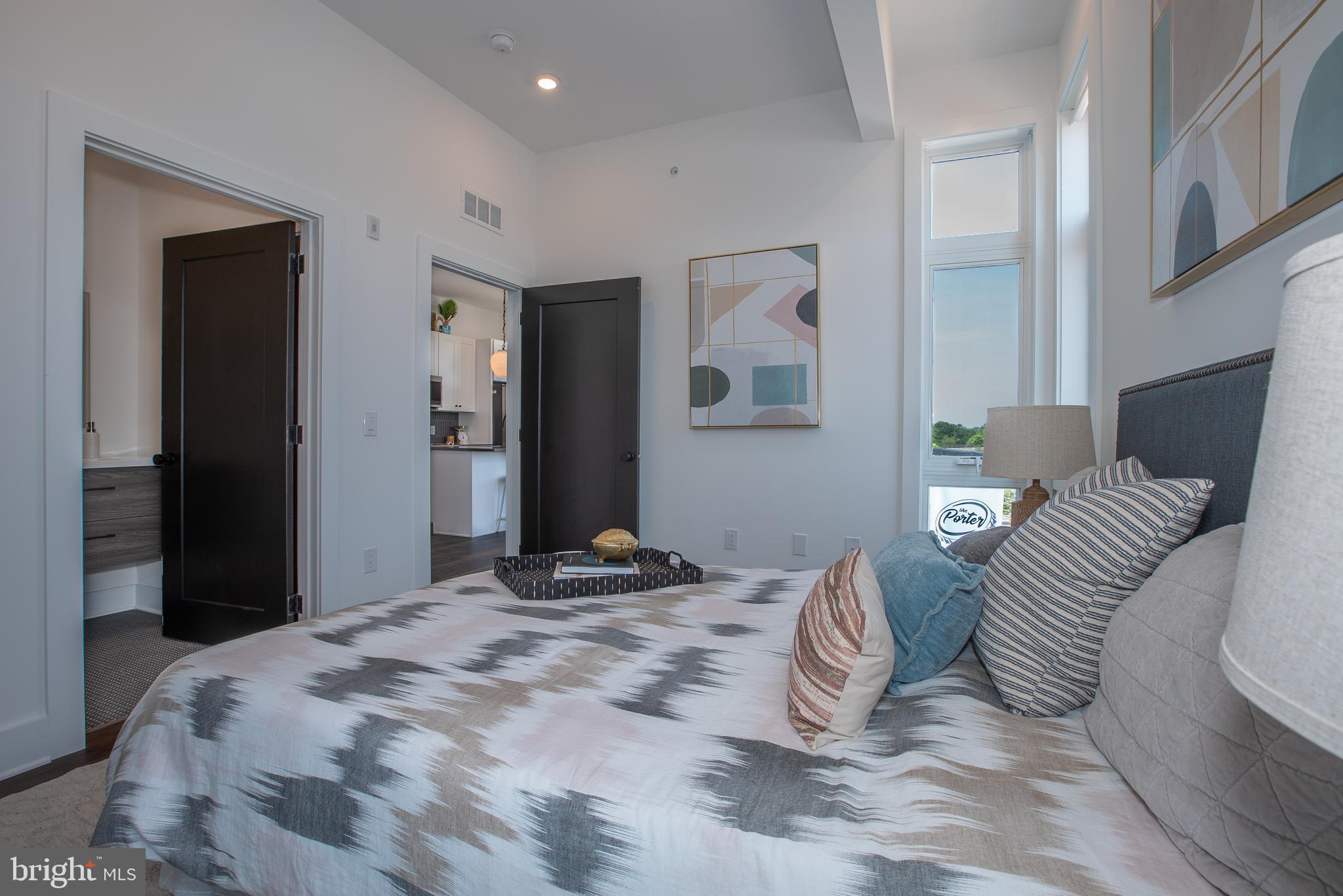 2940 West Thompson Street, Unit 302 Philadelphia, PA 19121 - Photo 35 of 43 a bedroom with bed and a painting on the wall