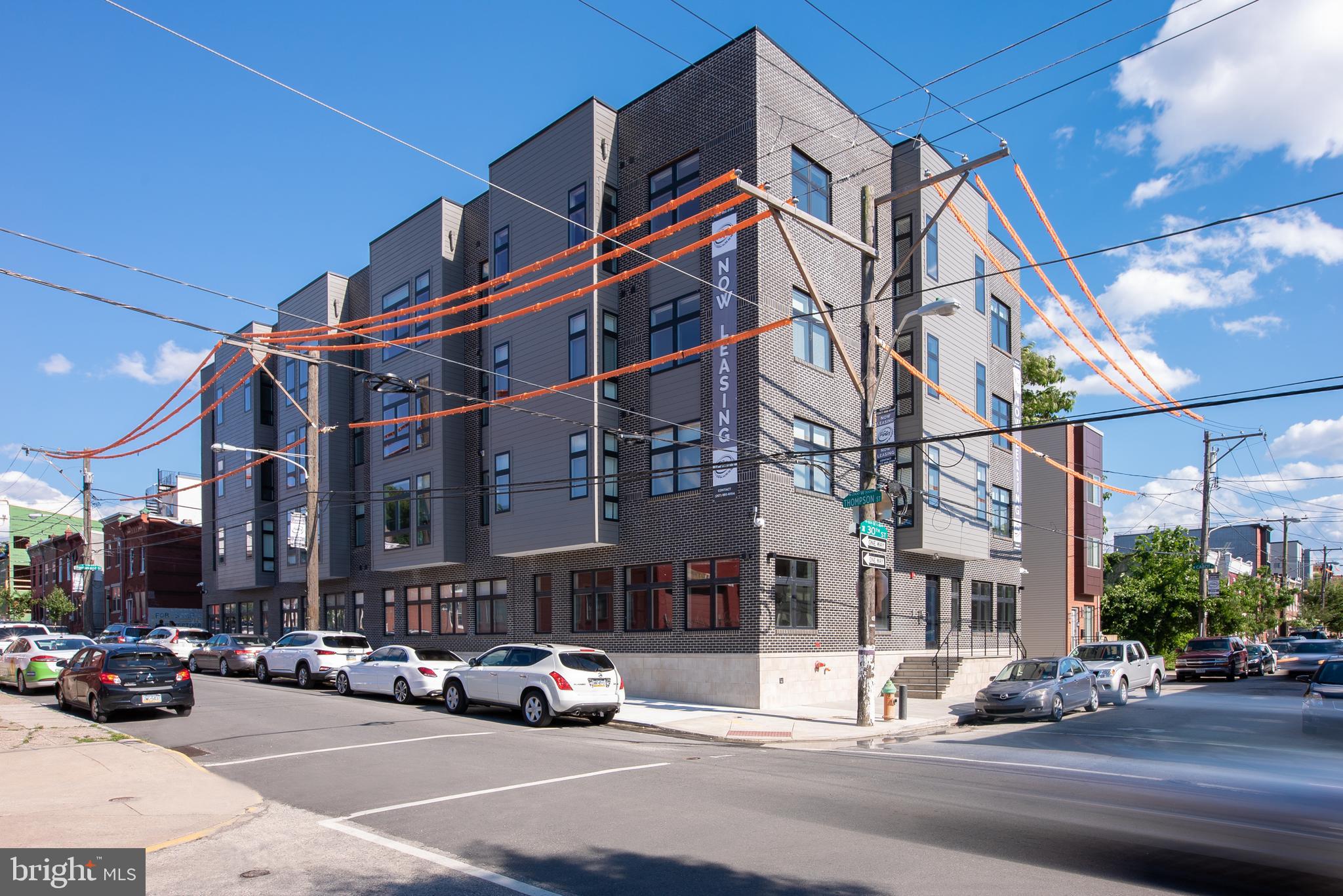 2940 West Thompson Street, Unit 302 Philadelphia, PA 19121 - Photo 8 of 43 a cars parked in front of a building