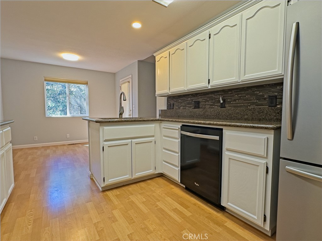 14279 Carnegie Road Magalia, CA 95954 - Photo 13 of 38 a kitchen with white cabinets and appliances