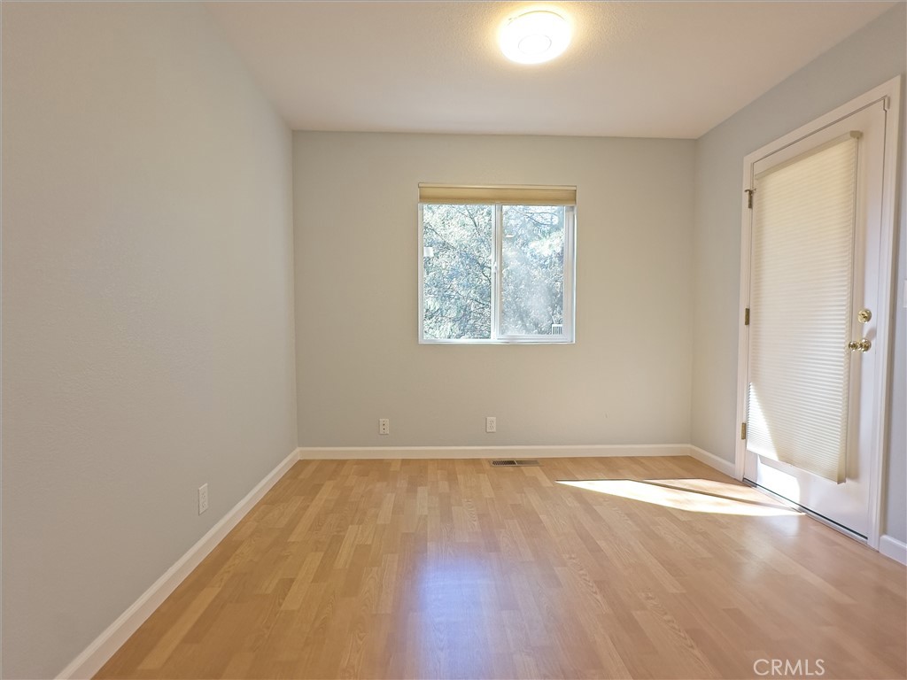 14279 Carnegie Road Magalia, CA 95954 - Photo 14 of 38 an empty room with wooden floor and windows