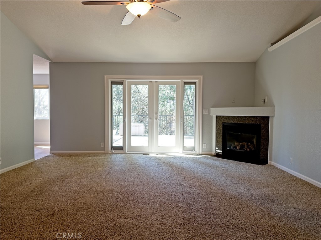 14279 Carnegie Road Magalia, CA 95954 - Photo 3 of 38 a view of an empty room with a fireplace and a window