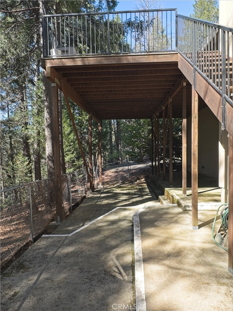 14279 Carnegie Road Magalia, CA 95954 - Photo 31 of 38 a view of a patio with table and chairs with wooden floor and fence