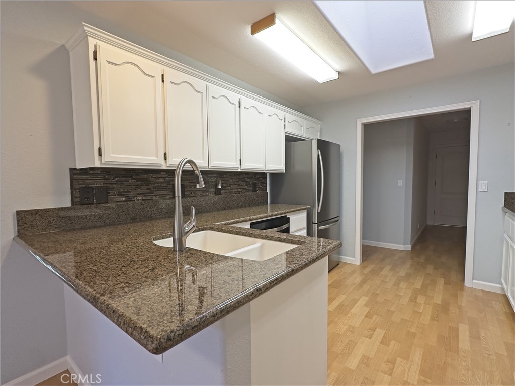 14279 Carnegie Road Magalia, CA 95954 - Photo 9 of 38 a kitchen with granite countertop a sink a counter top space cabinets and stainless steel appliances