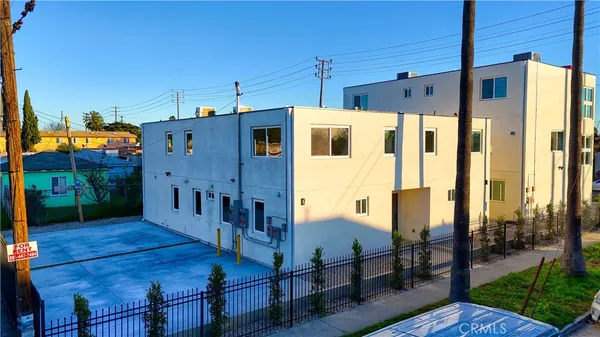 a view of a house with wooden fence