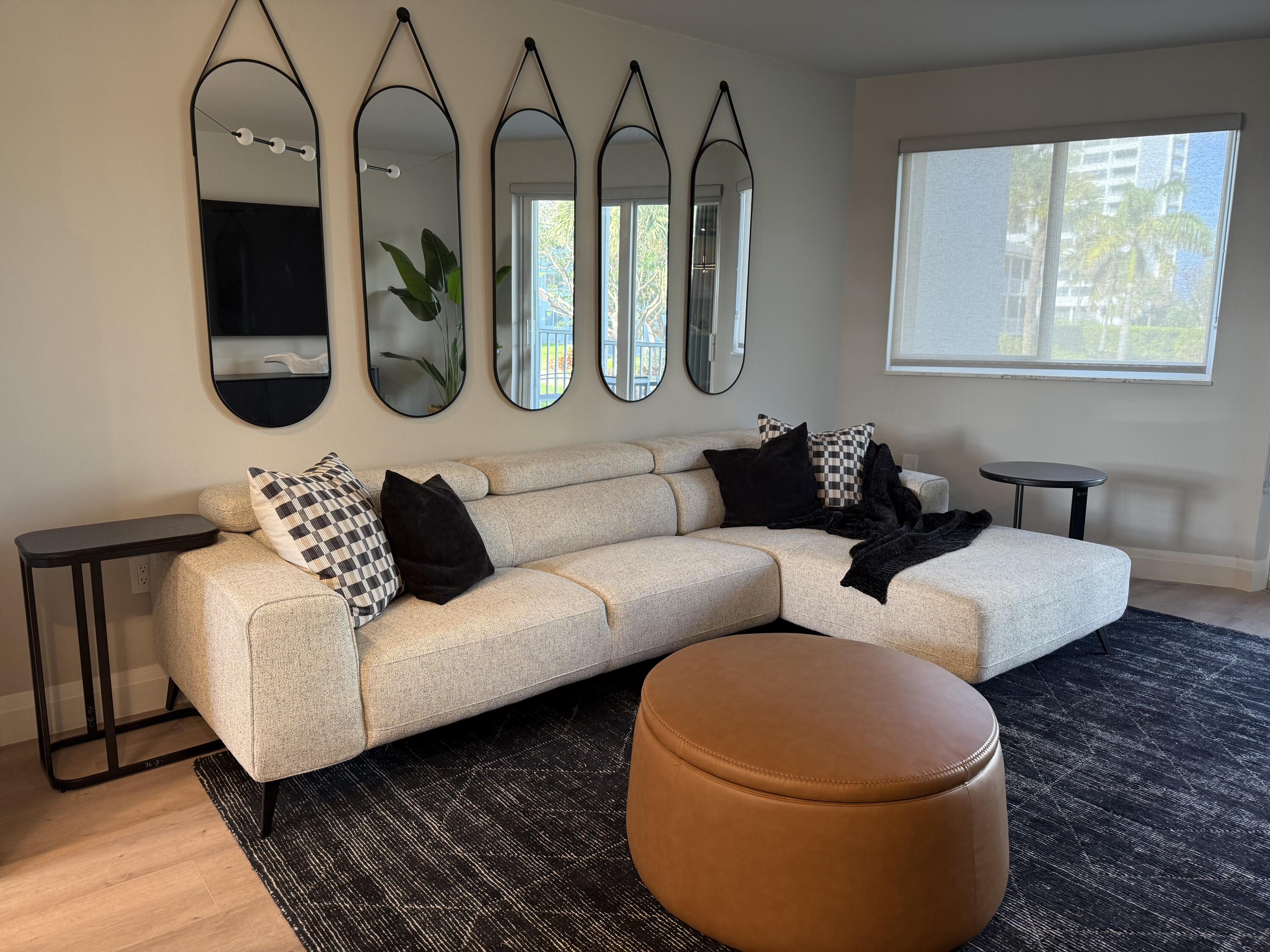 2730 Banyan Road, Unit 23B Boca Raton, FL 33432 - Photo 1 of 5 a living room with furniture and a large window