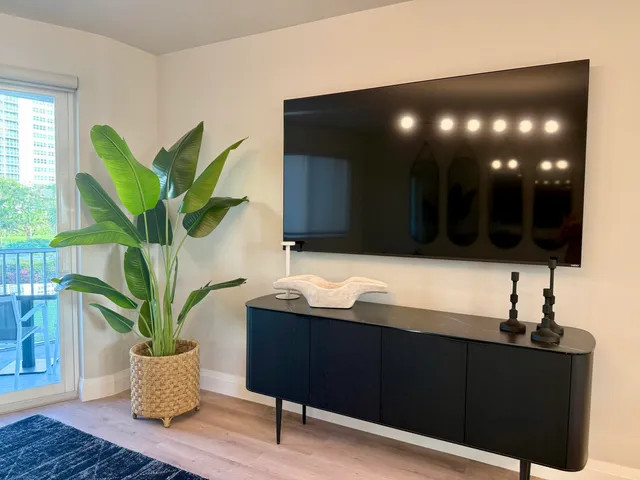 a bathroom with a sink and a potted plant