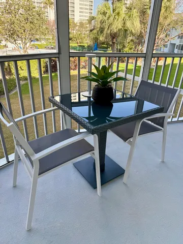 a view of porch with furniture and a window