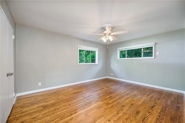 wooden floor in an empty room with a window