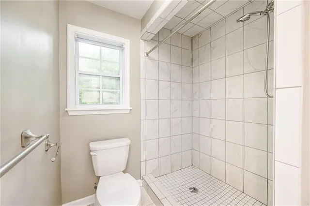 a bathroom with a toilet and a shower