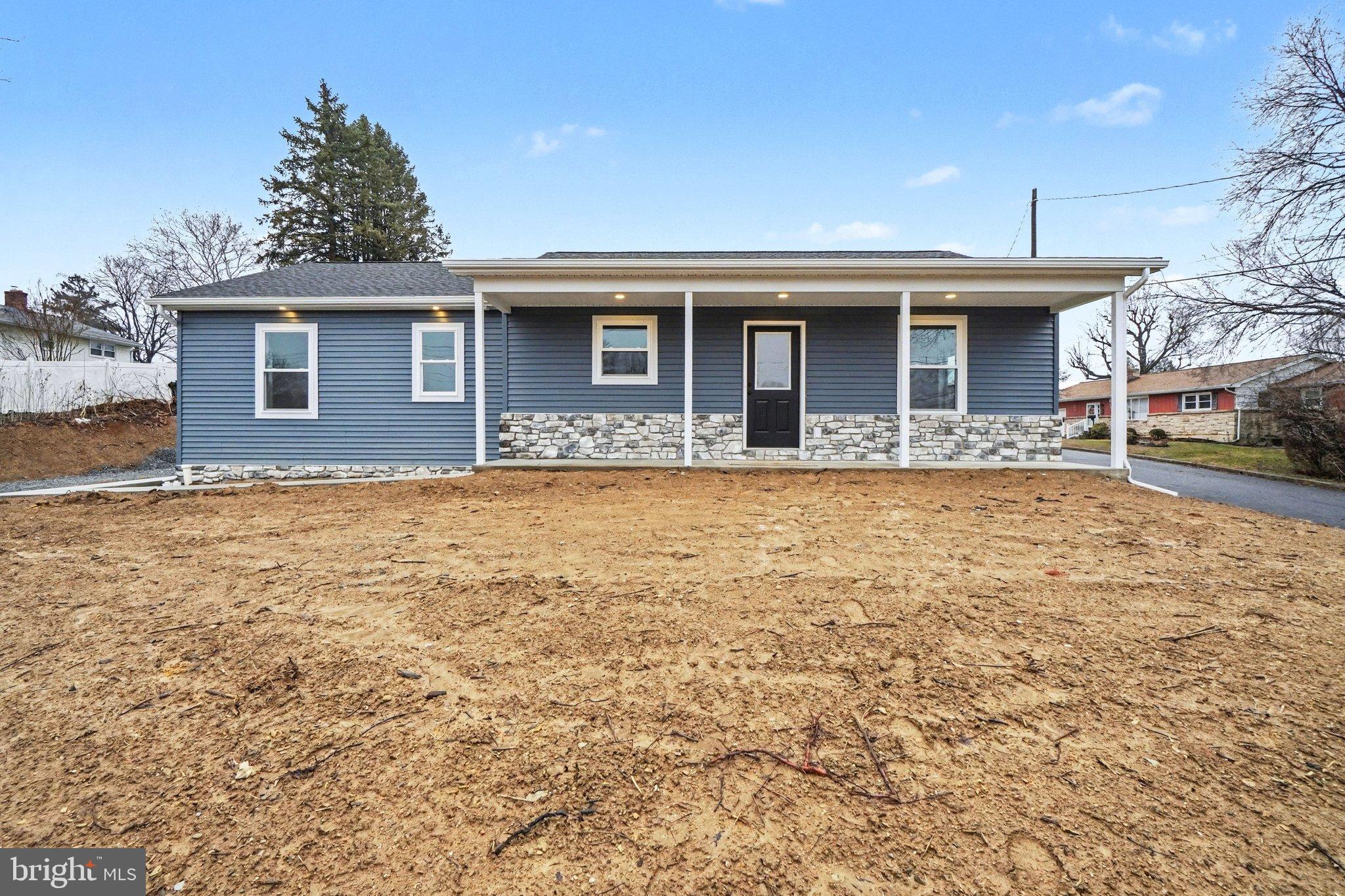 Charming blue home with inviting porch.
