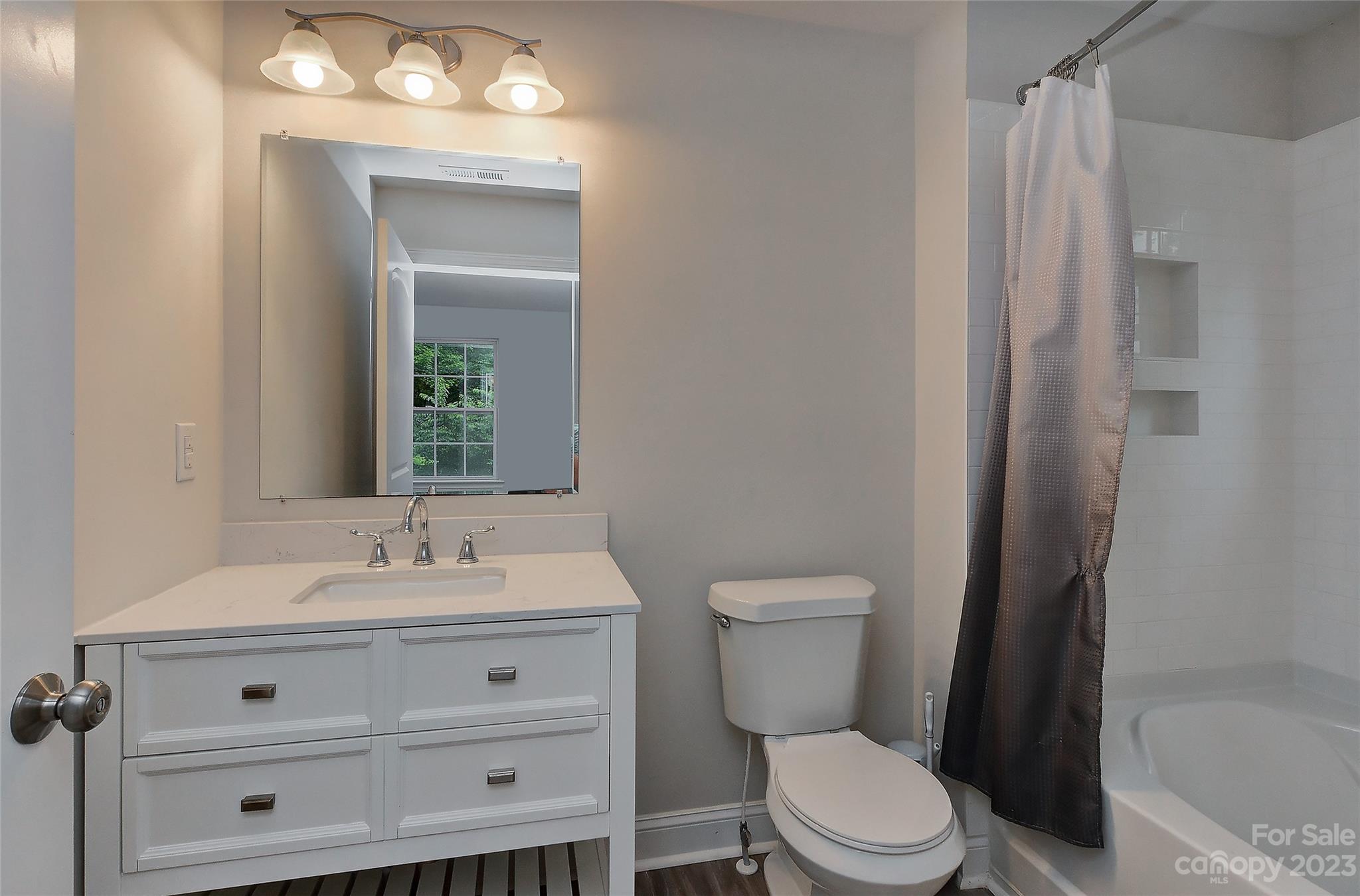 6413 McBride Street Charlotte, NC 28215 - Photo 17 of 21 a bathroom with a sink vanity mirror and toilet