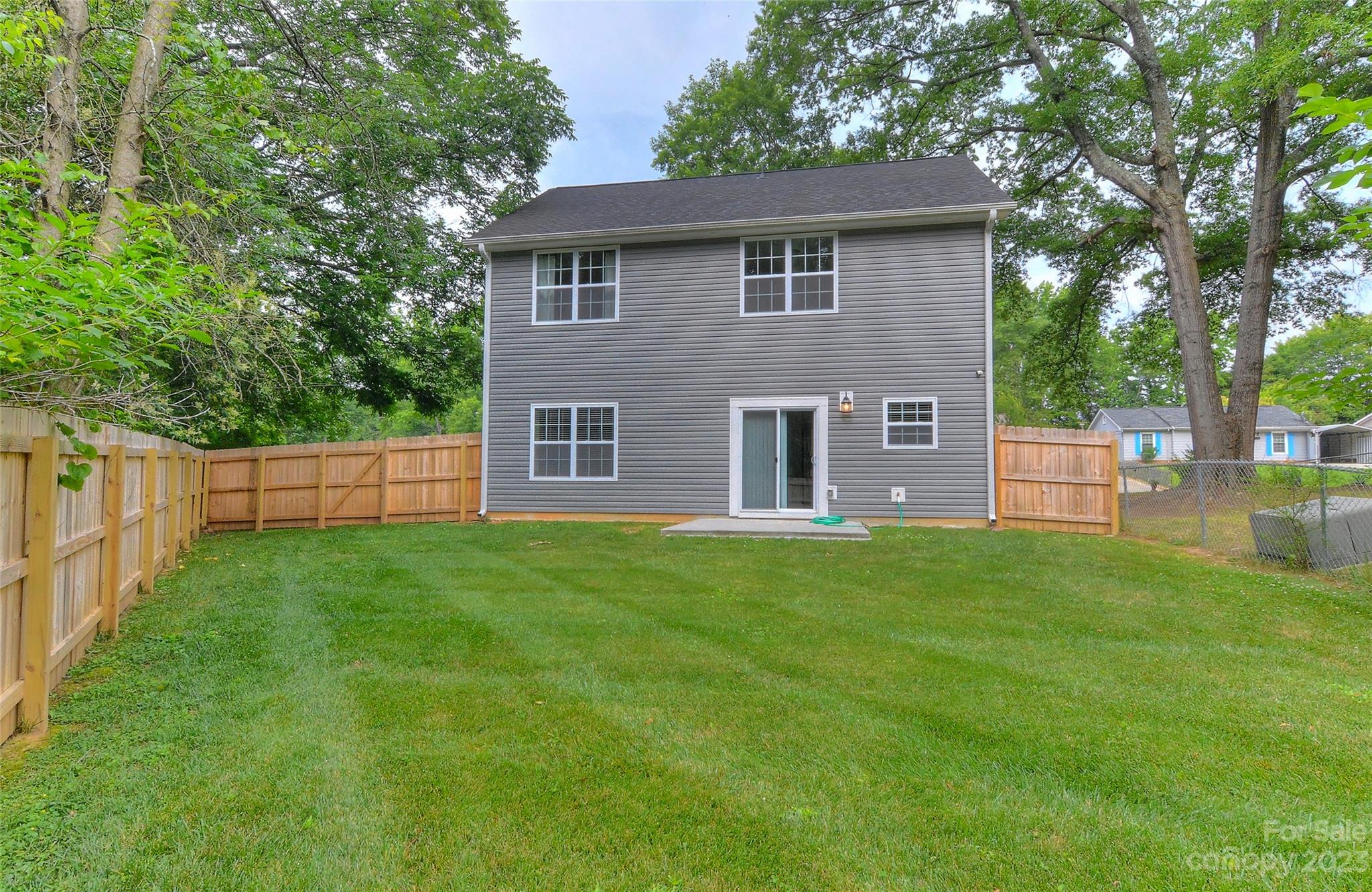 6413 McBride Street Charlotte, NC 28215 - Photo 19 of 21 a brick house with a big yard and large trees