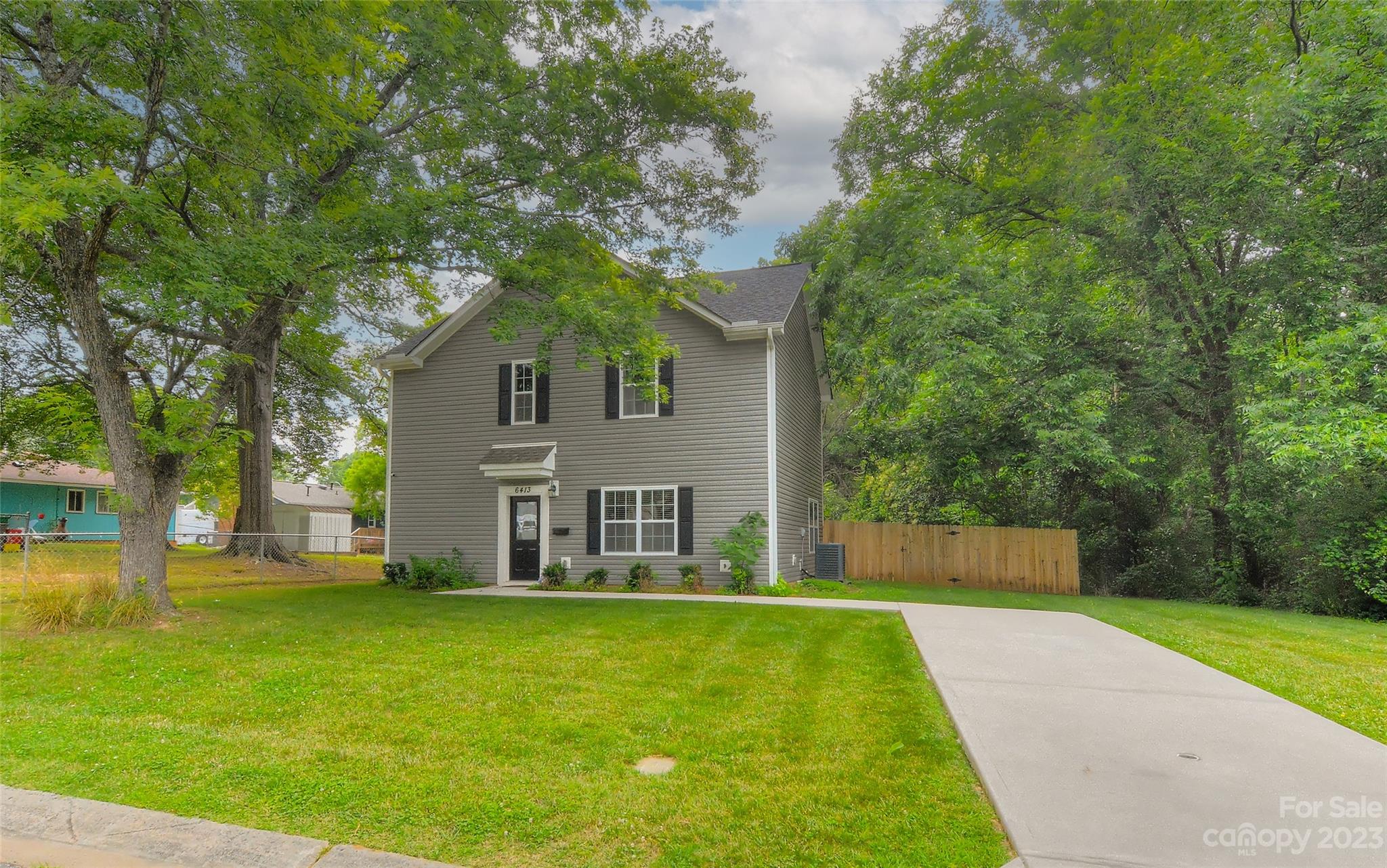 6413 McBride Street Charlotte, NC 28215 - Photo 2 of 21 a front view of house with yard and trees in the background