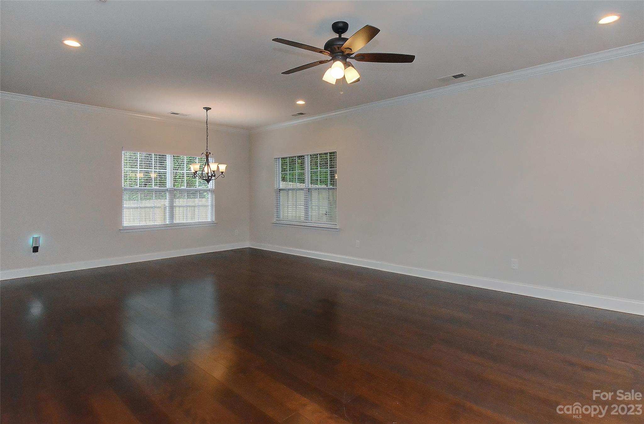 6413 McBride Street Charlotte, NC 28215 - Photo 3 of 21 an empty room with wooden floor and window